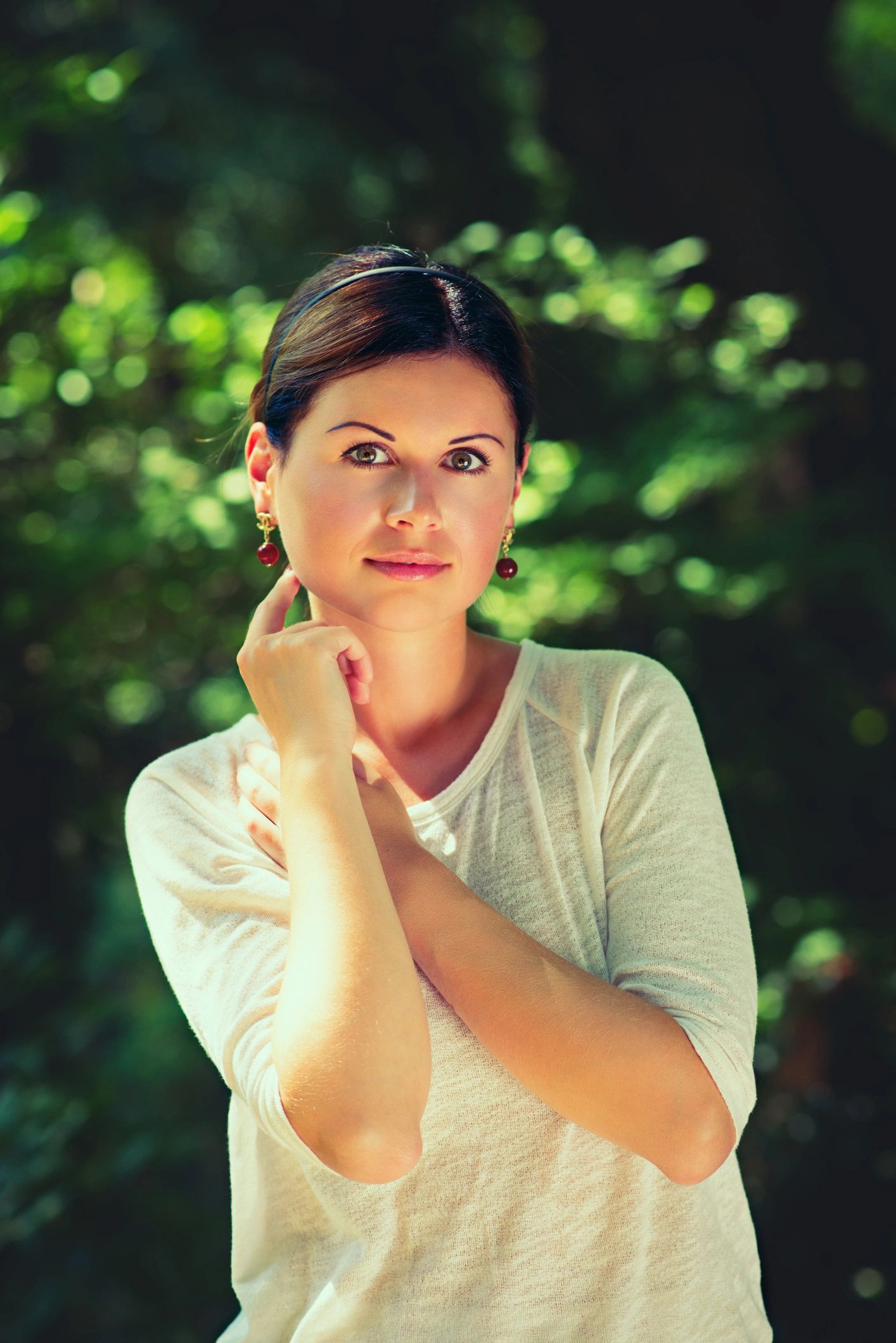Woman among green trees